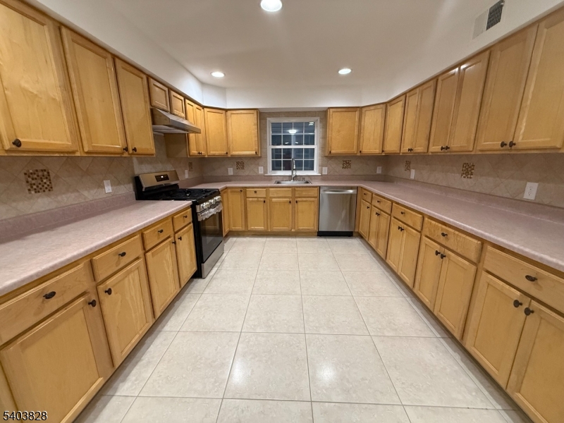 527 4th Avenue, Unit 1 Elizabeth, NJ 07202 - Photo 7 of 21 a large kitchen with stainless steel appliances lots of counter top space