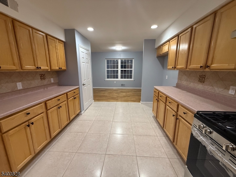 527 4th Avenue, Unit 1 Elizabeth, NJ 07202 - Photo 8 of 21 a large kitchen with stainless steel appliances granite countertop a stove a sink and a microwave