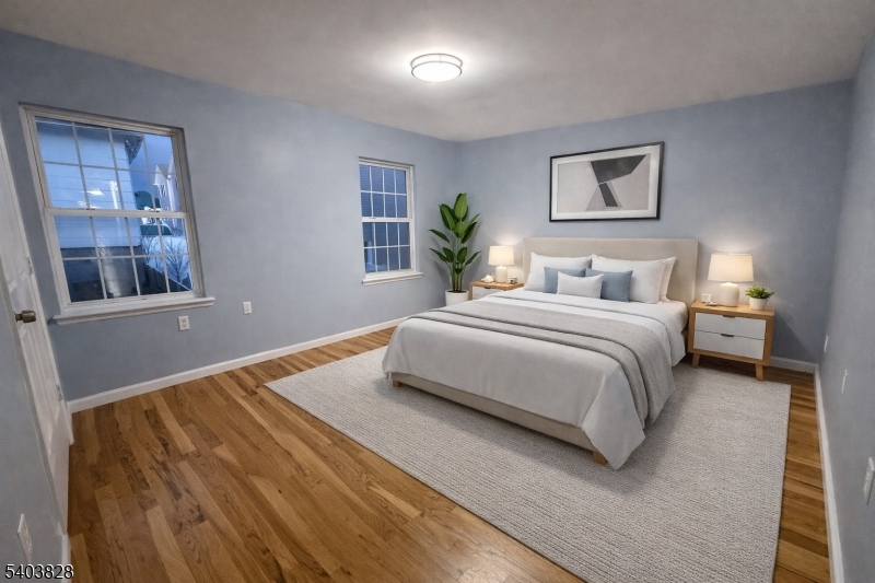 527 4th Avenue, Unit 1 Elizabeth, NJ 07202 - Photo 10 of 21 a bedroom with a bed and a painting on the wall