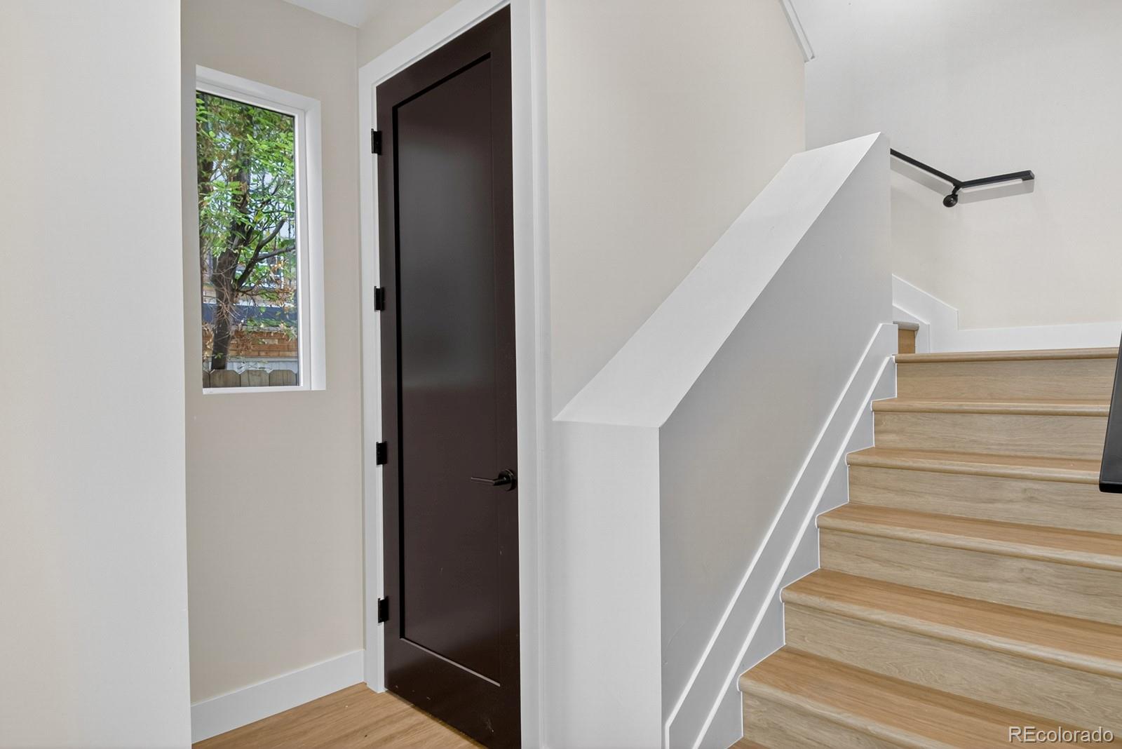 832 North Cherry Street, Unit 1 Denver, CO 80220 - Photo 15 of 41 a view of entryway with wooden floor and stairs