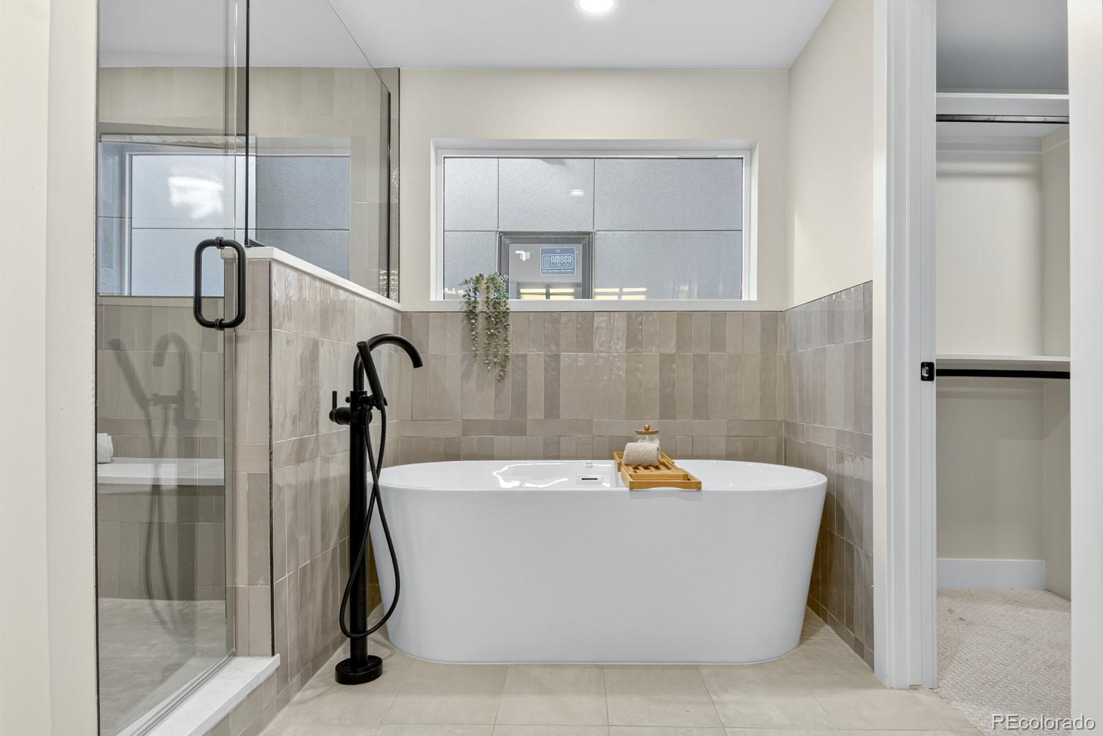 832 North Cherry Street, Unit 1 Denver, CO 80220 - Photo 20 of 41 a white bath tub sitting in a bathroom