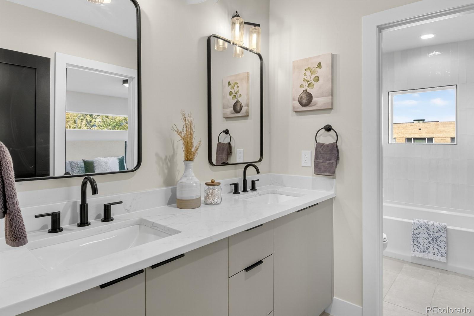 832 North Cherry Street, Unit 1 Denver, CO 80220 - Photo 28 of 41 a bathroom with double vanity sinks and a mirror