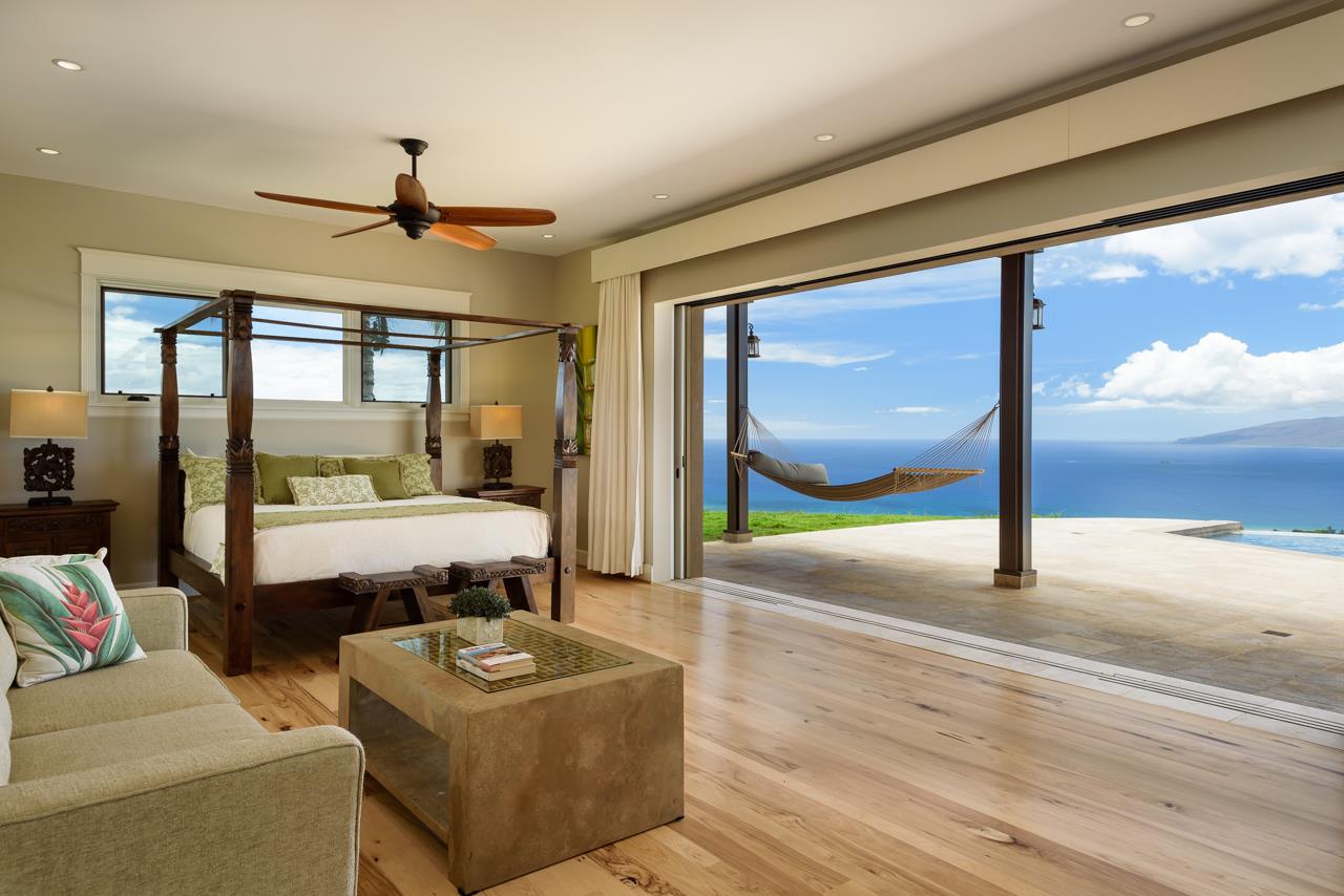554 Punakea Loop Lahaina, HI 96761 - Photo 11 of 30 a living room with a couch a table and a floor to ceiling window
