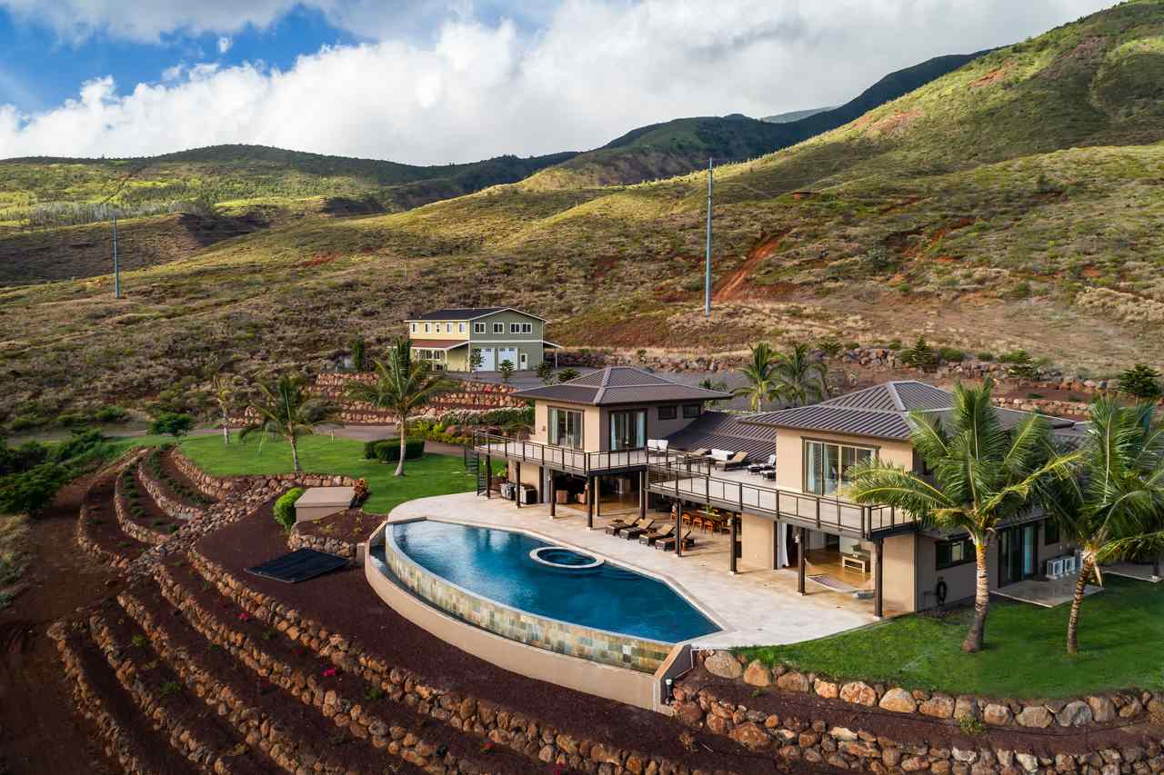 554 Punakea Loop Lahaina, HI 96761 - Photo 23 of 30 a view of a swimming pool with lawn chairs and a large tree