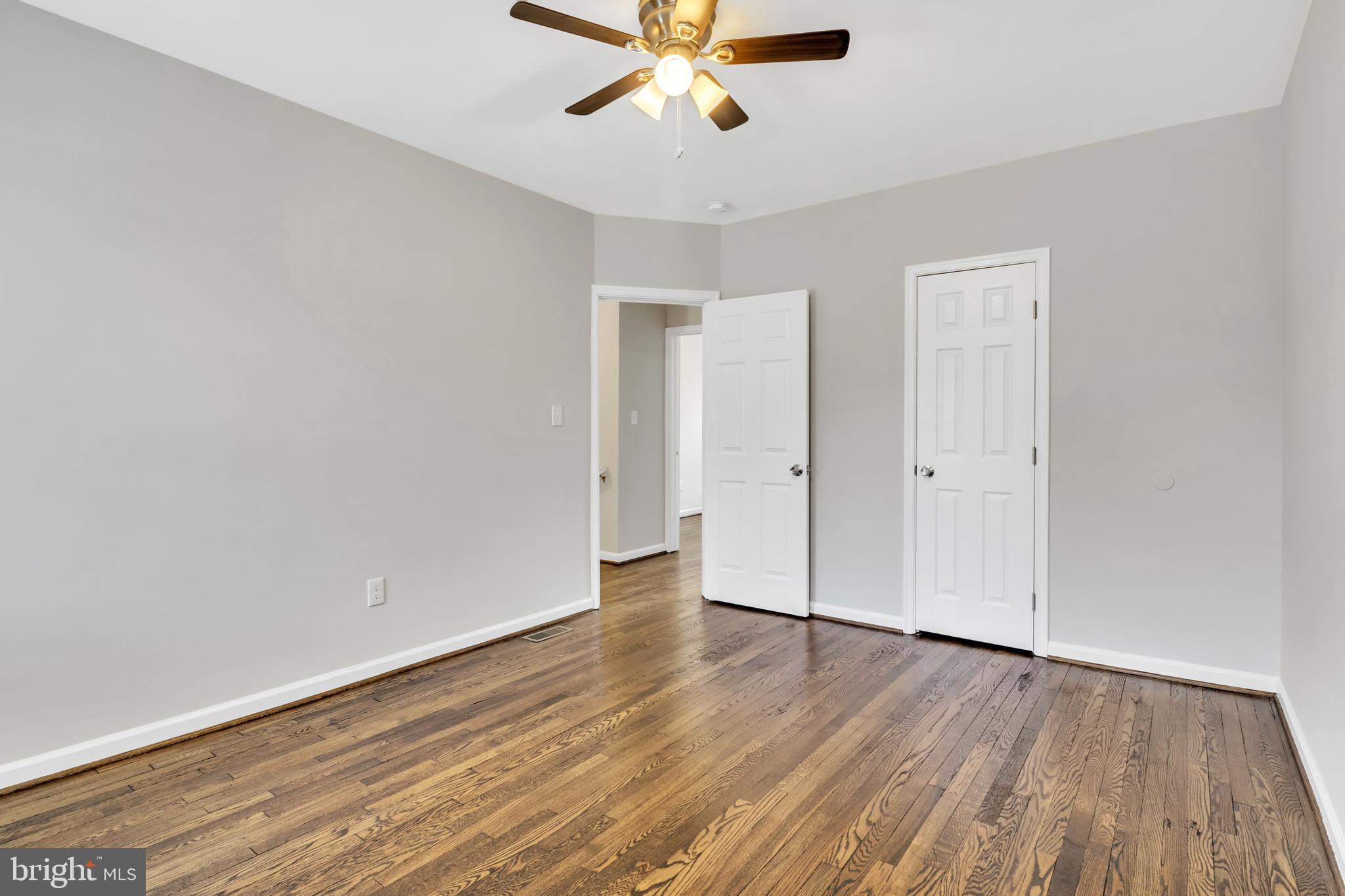 4437 Old York Road Baltimore, MD 21212 - Photo 14 of 15 an empty room with wooden floor and windows