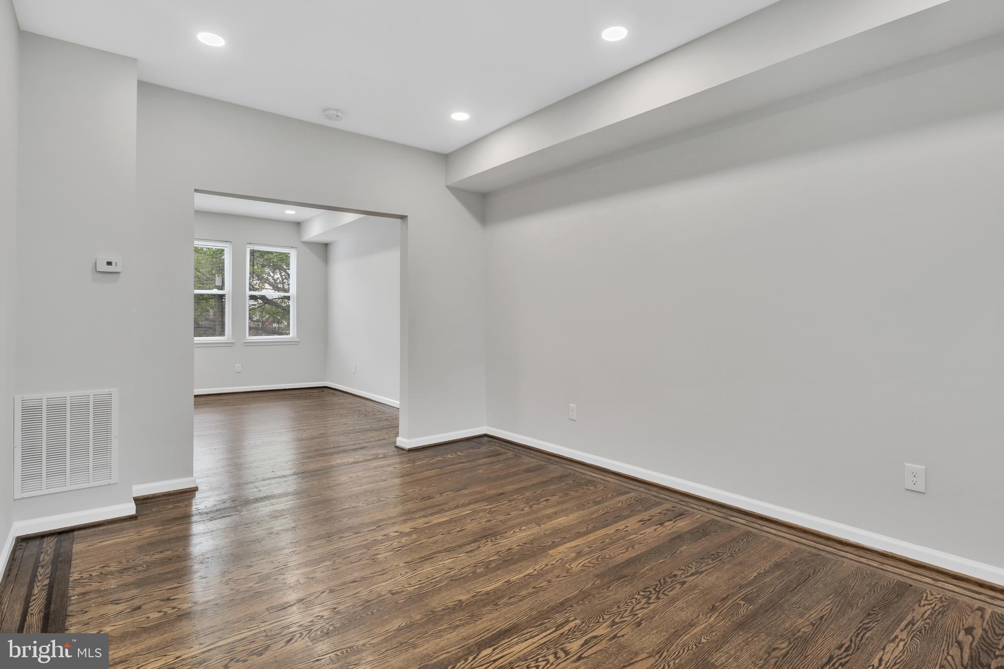 4437 Old York Road Baltimore, MD 21212 - Photo 2 of 15 a view of an empty room with wooden floor and a window