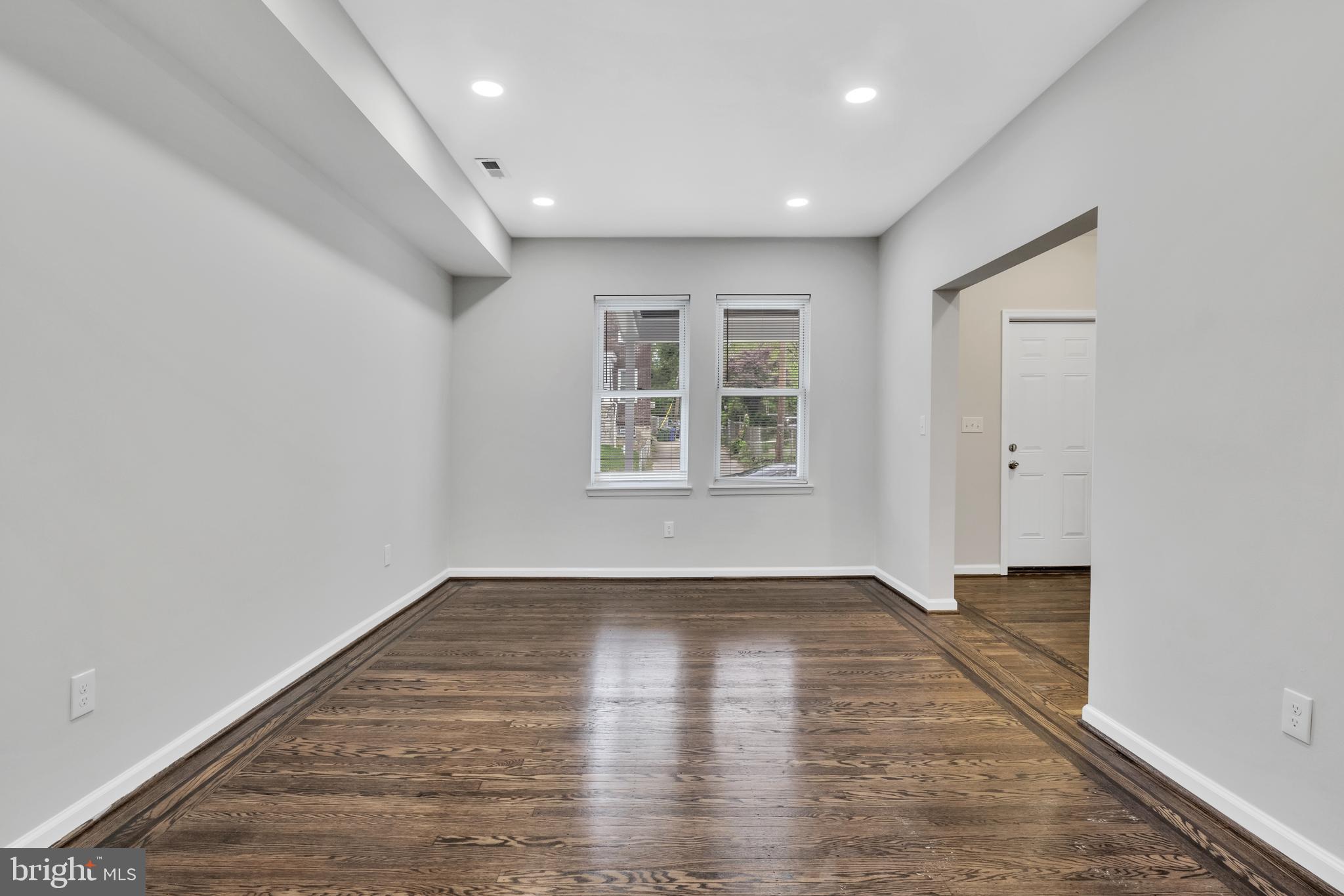 4437 Old York Road Baltimore, MD 21212 - Photo 4 of 15 an empty room with wooden floor and windows