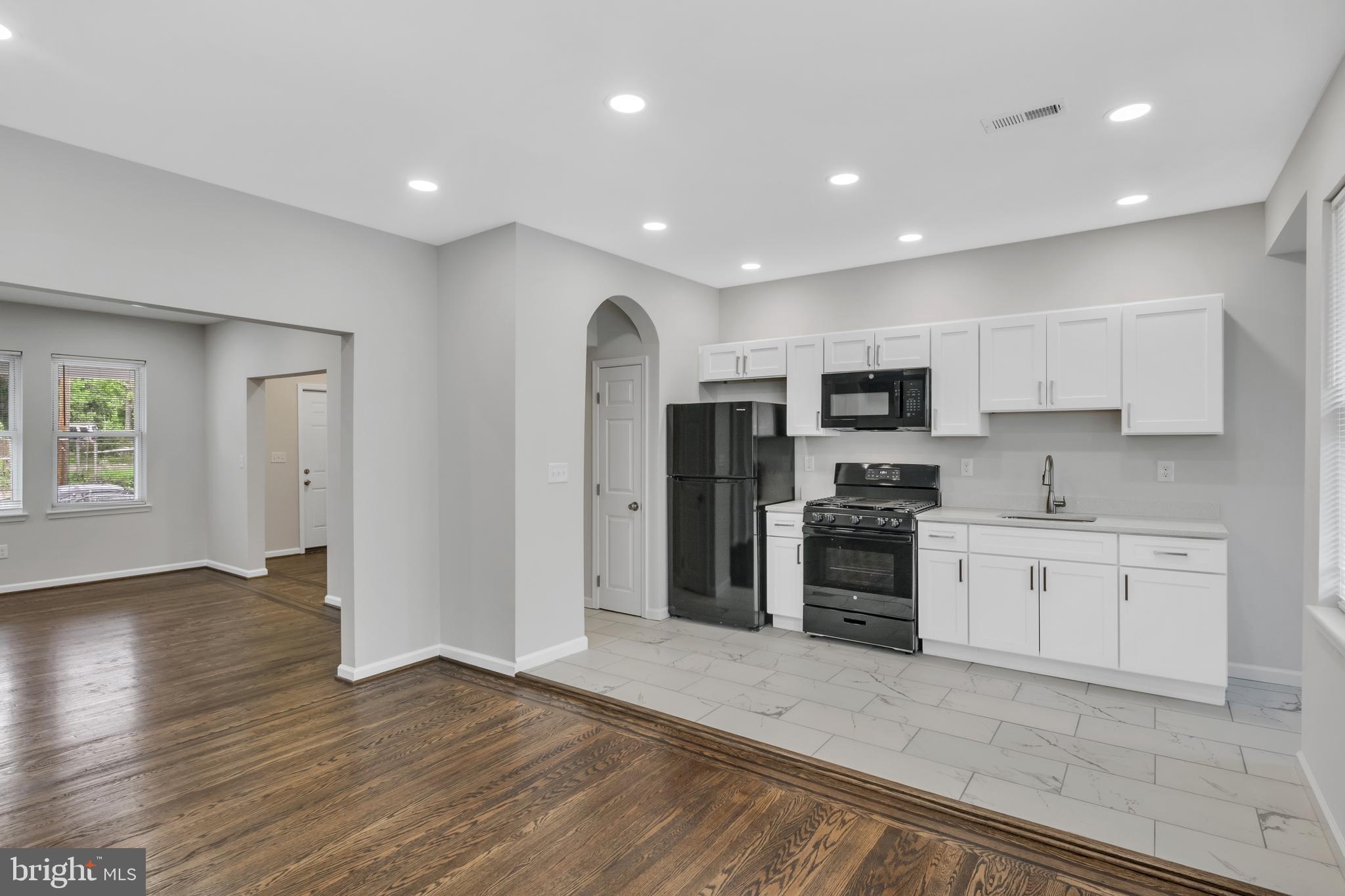 4437 Old York Road Baltimore, MD 21212 - Photo 5 of 15 a large kitchen with stainless steel appliances granite countertop a stove and a refrigerator