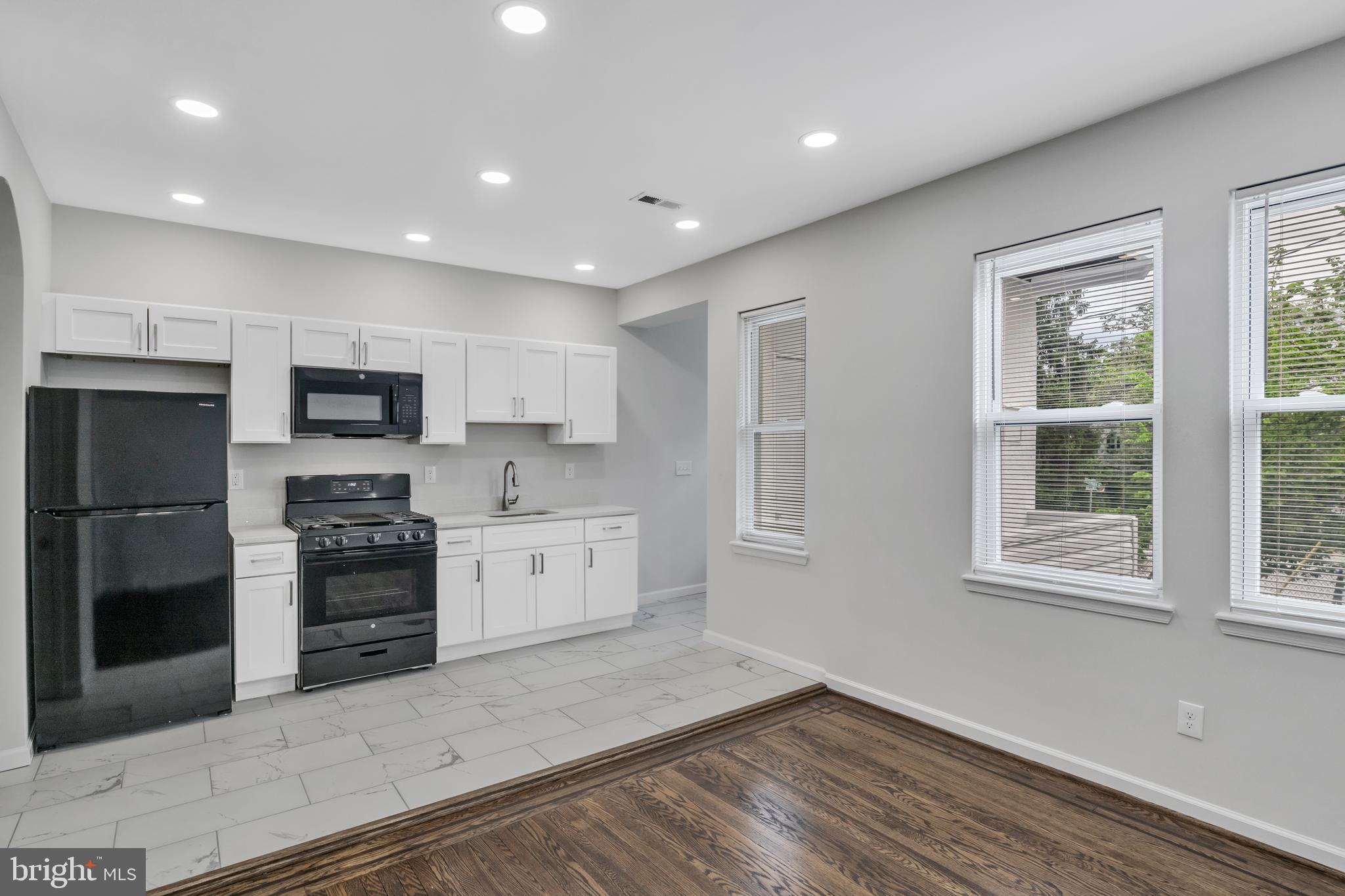 4437 Old York Road Baltimore, MD 21212 - Photo 6 of 15 a kitchen with stainless steel appliances granite countertop a stove a sink and a refrigerator