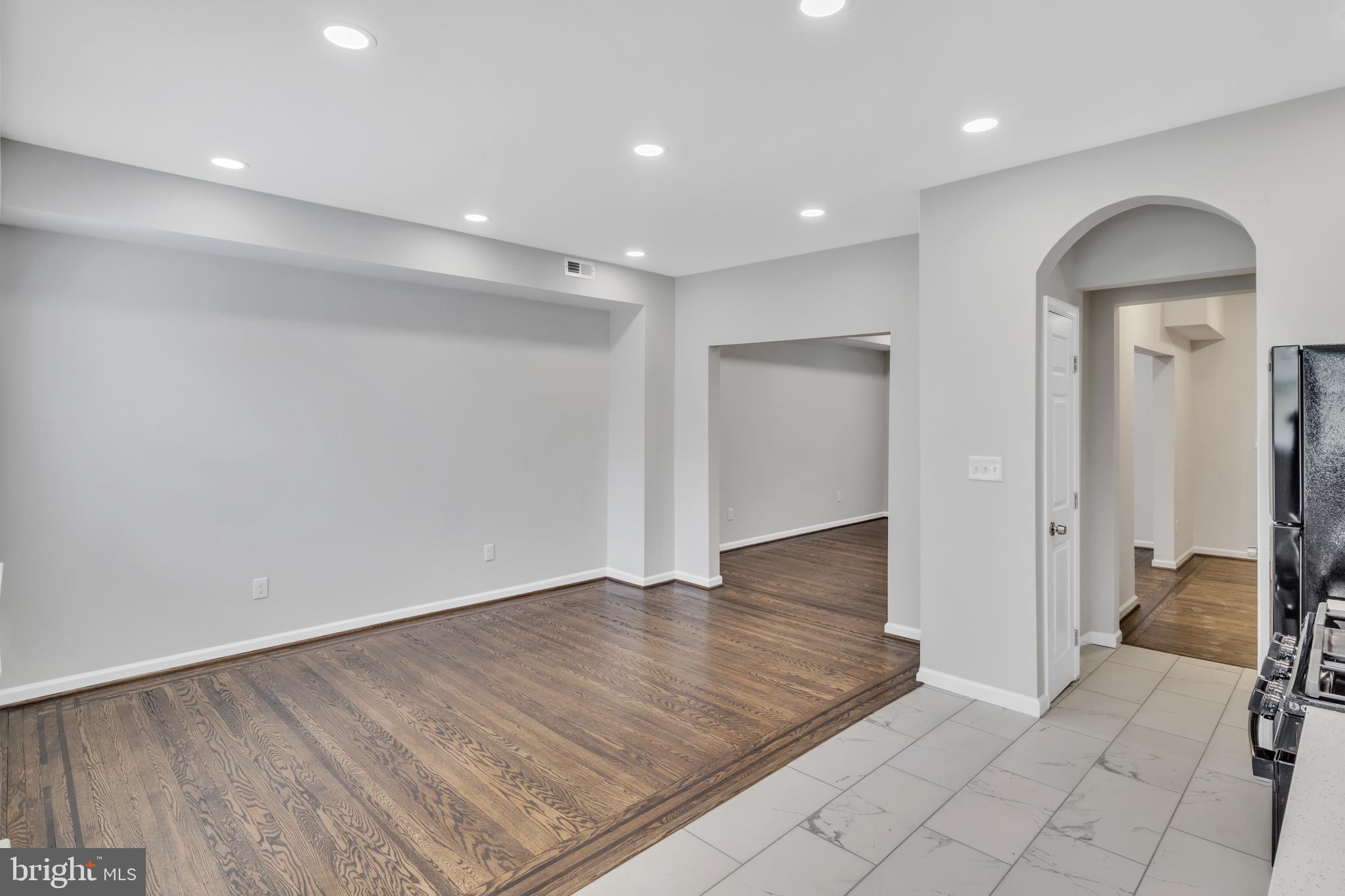 4437 Old York Road Baltimore, MD 21212 - Photo 7 of 15 an empty room with wooden floor & bathroom