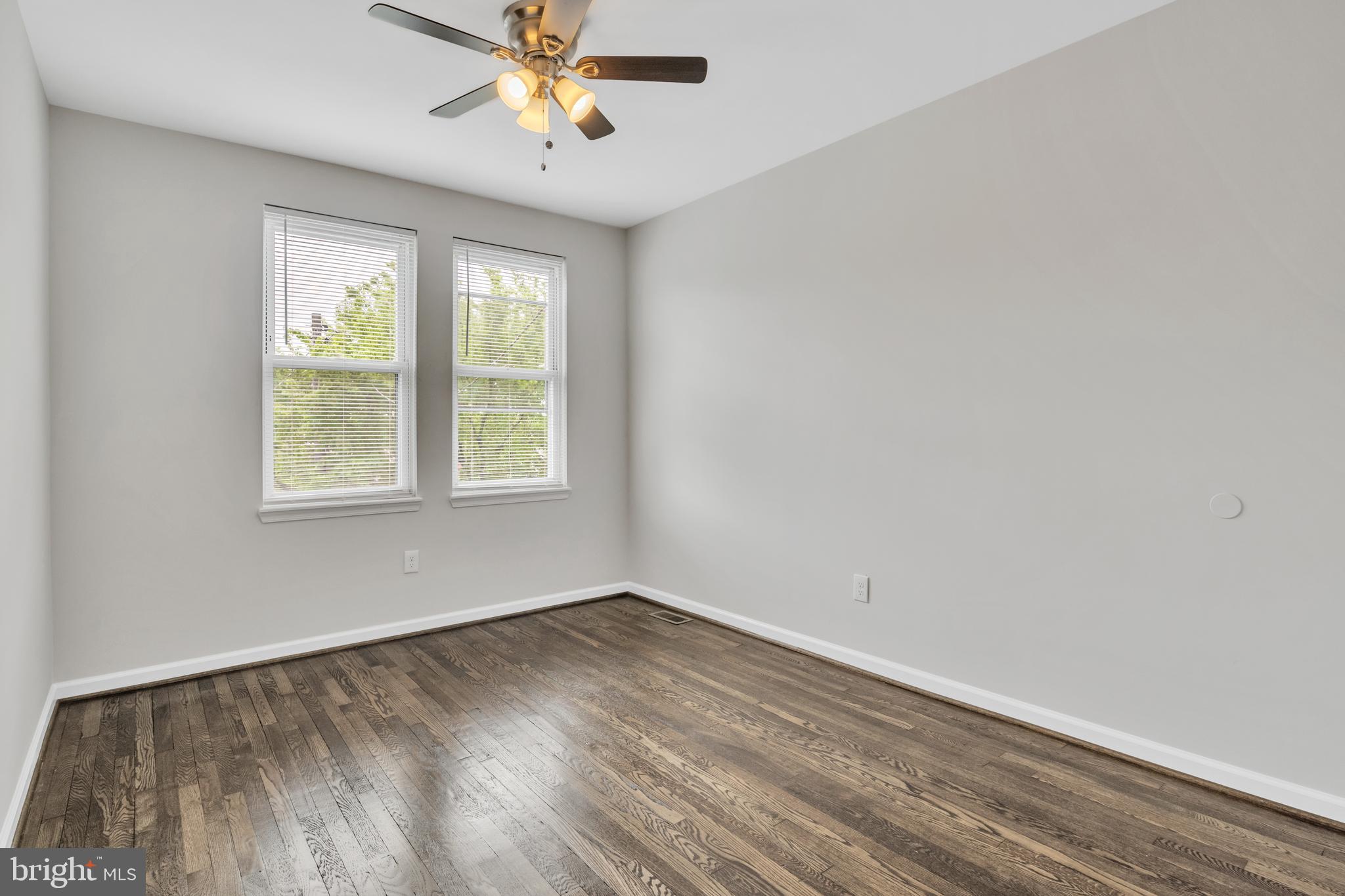 4437 Old York Road Baltimore, MD 21212 - Photo 10 of 15 wooden floor in an empty room with a window