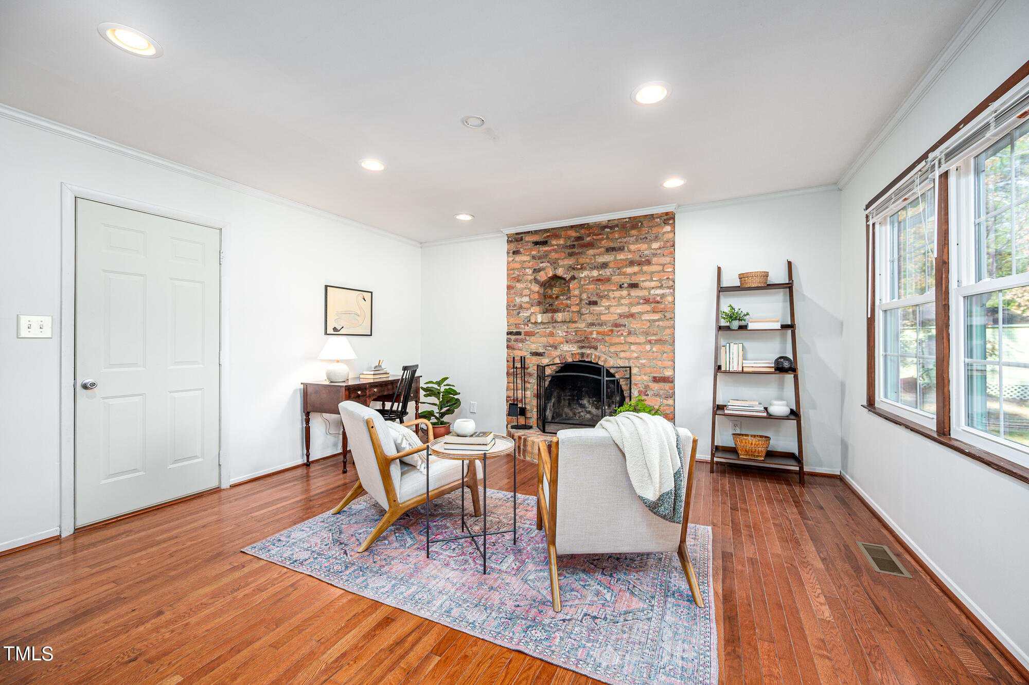 5215 Pelham Road Durham, NC 27713 - Photo 18 of 45 a living room with furniture a fireplace and a table