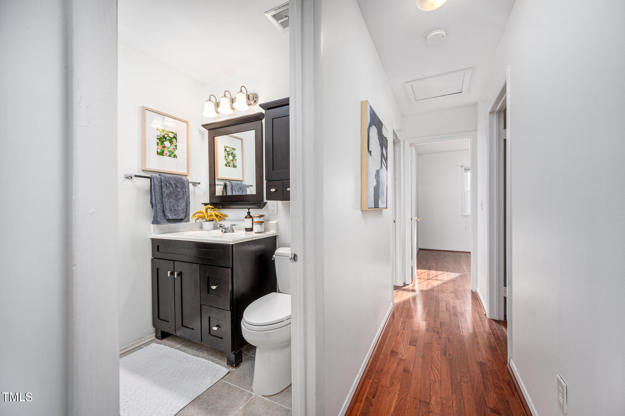 5215 Pelham Road Durham, NC 27713 - Photo 22 of 45 a bathroom with a toilet sink and mirror