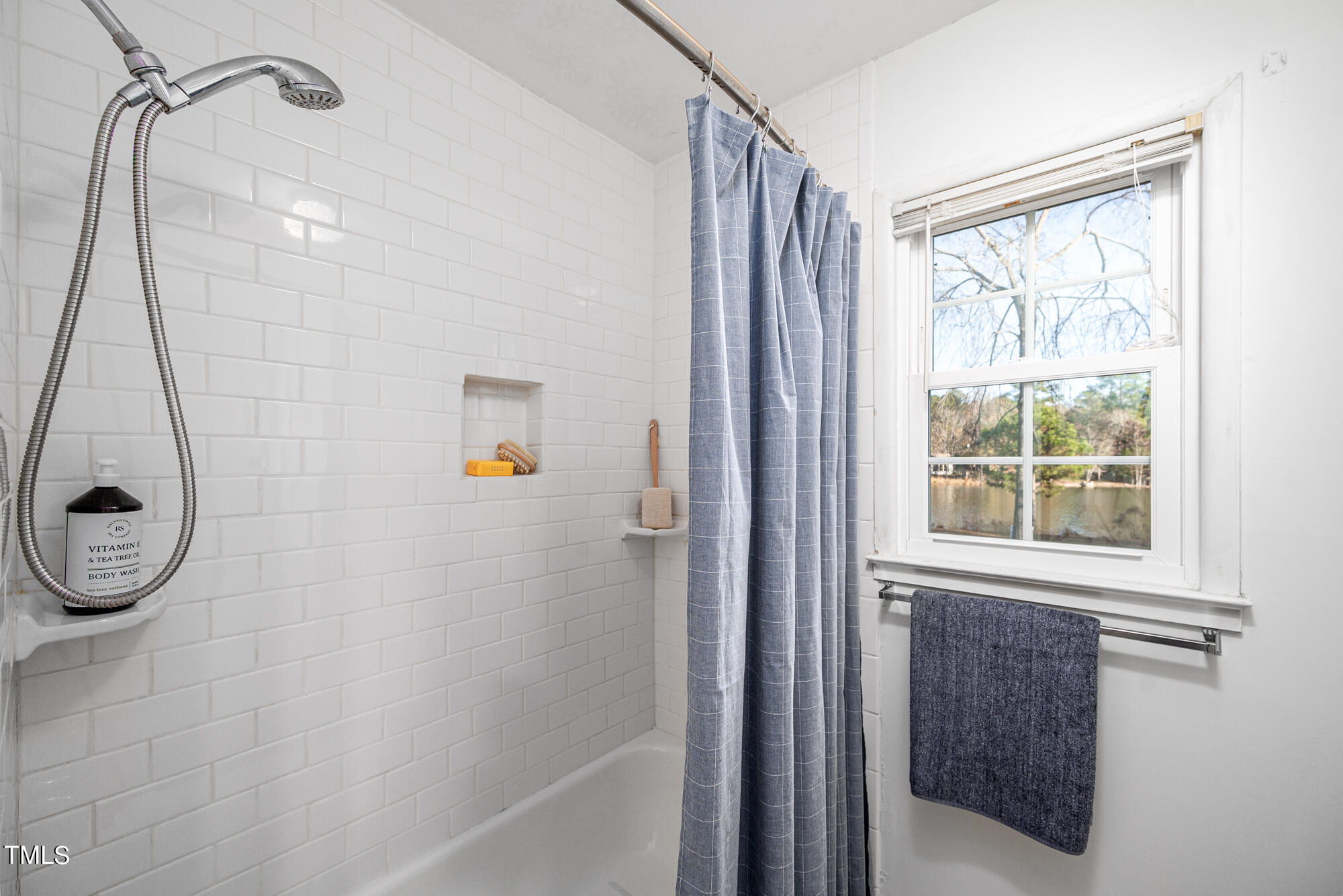 5215 Pelham Road Durham, NC 27713 - Photo 24 of 45 a bathroom with a shower and a window