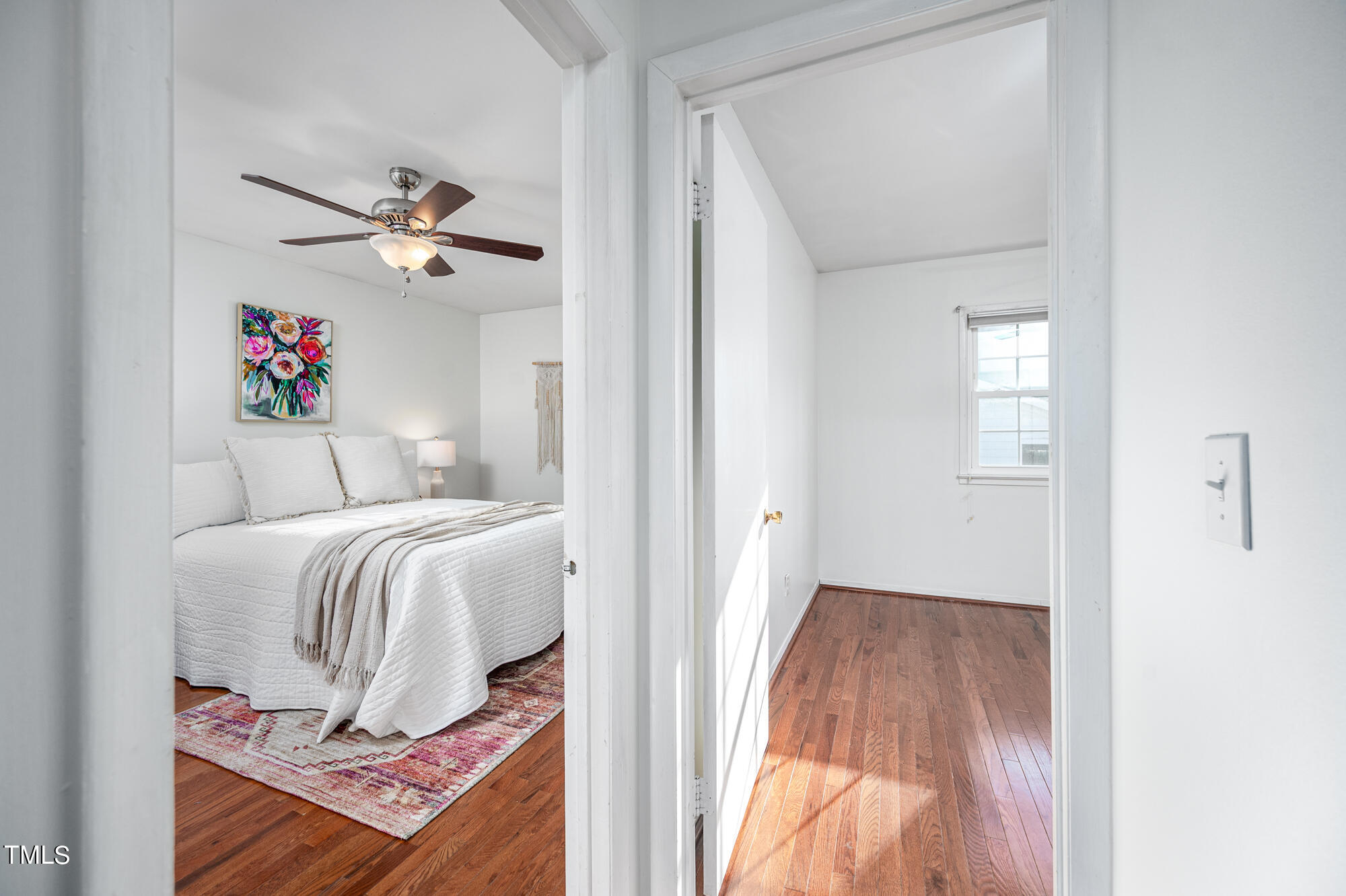 5215 Pelham Road Durham, NC 27713 - Photo 25 of 45 a bedroom with a bed and a chandelier