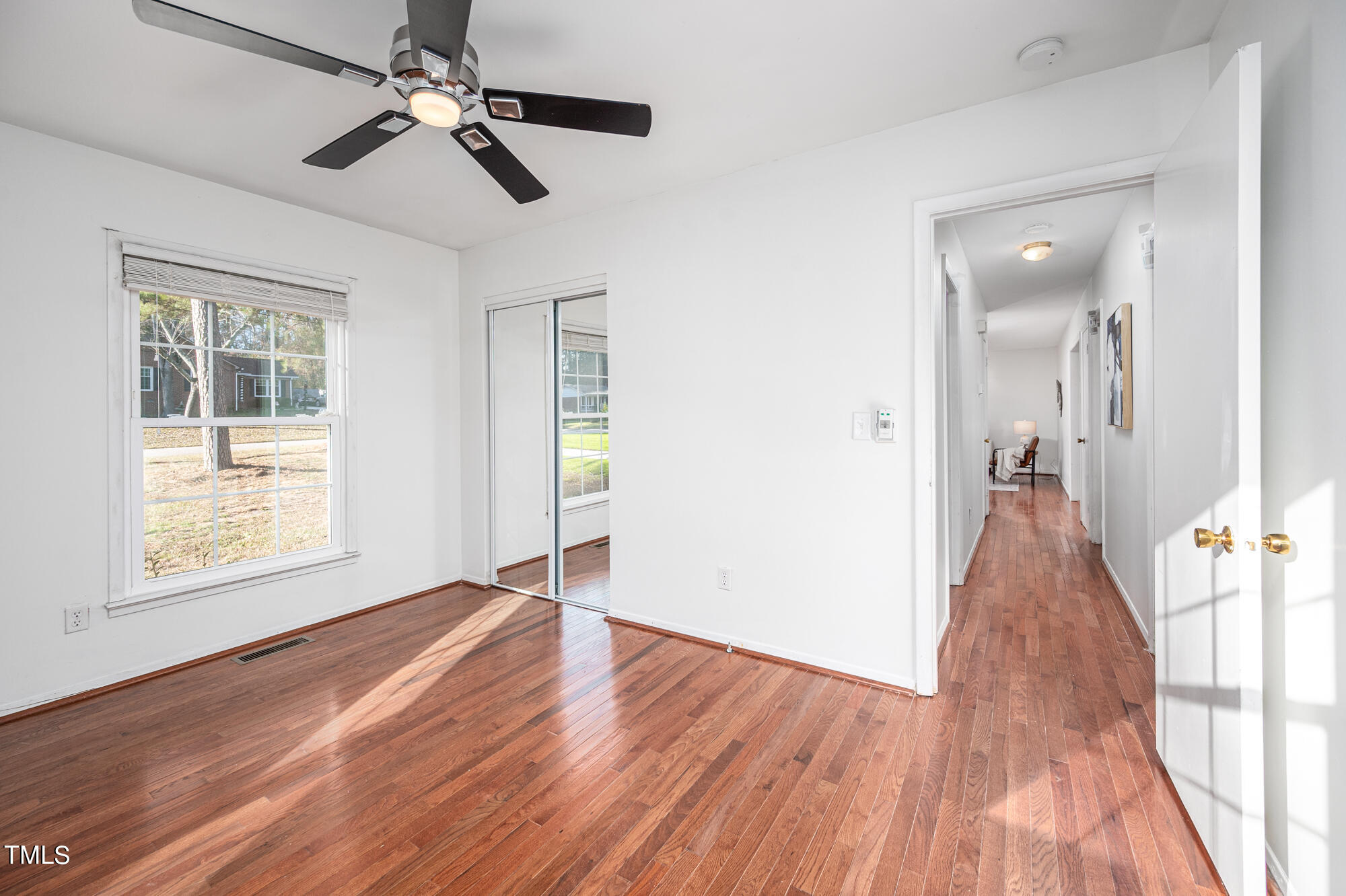5215 Pelham Road Durham, NC 27713 - Photo 33 of 45 an empty room with wooden floor fan and windows