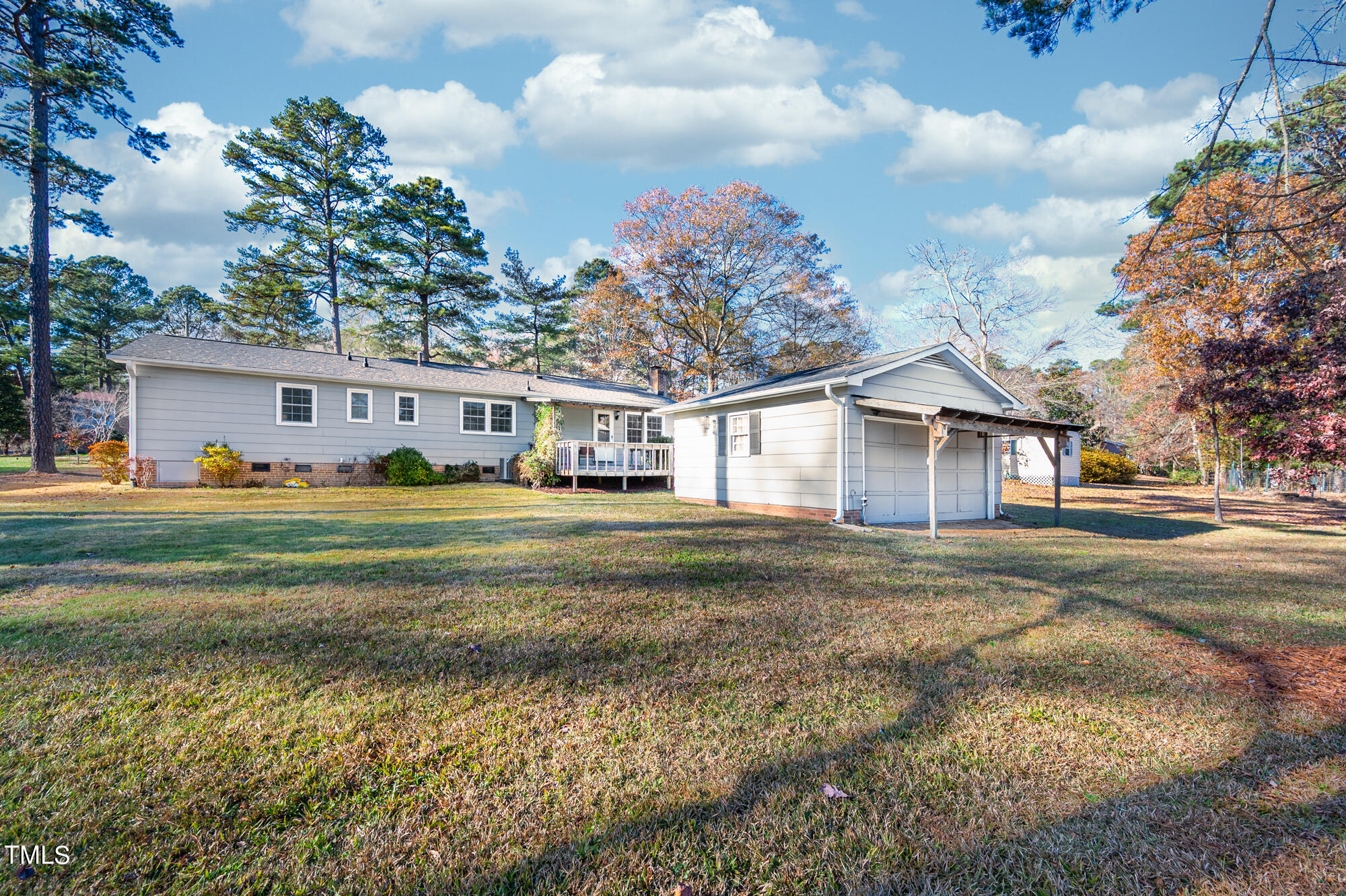 5215 Pelham Road Durham, NC 27713 - Photo 40 of 45 a view of a white house next to a yard with big trees