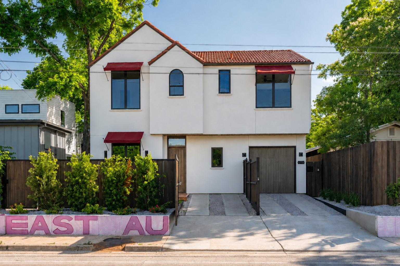 4713 Bolm Road Austin, TX 78702 - Photo 1 of 40 Contemporary stucco facade with a terracotta tile roof, accented by red awnings