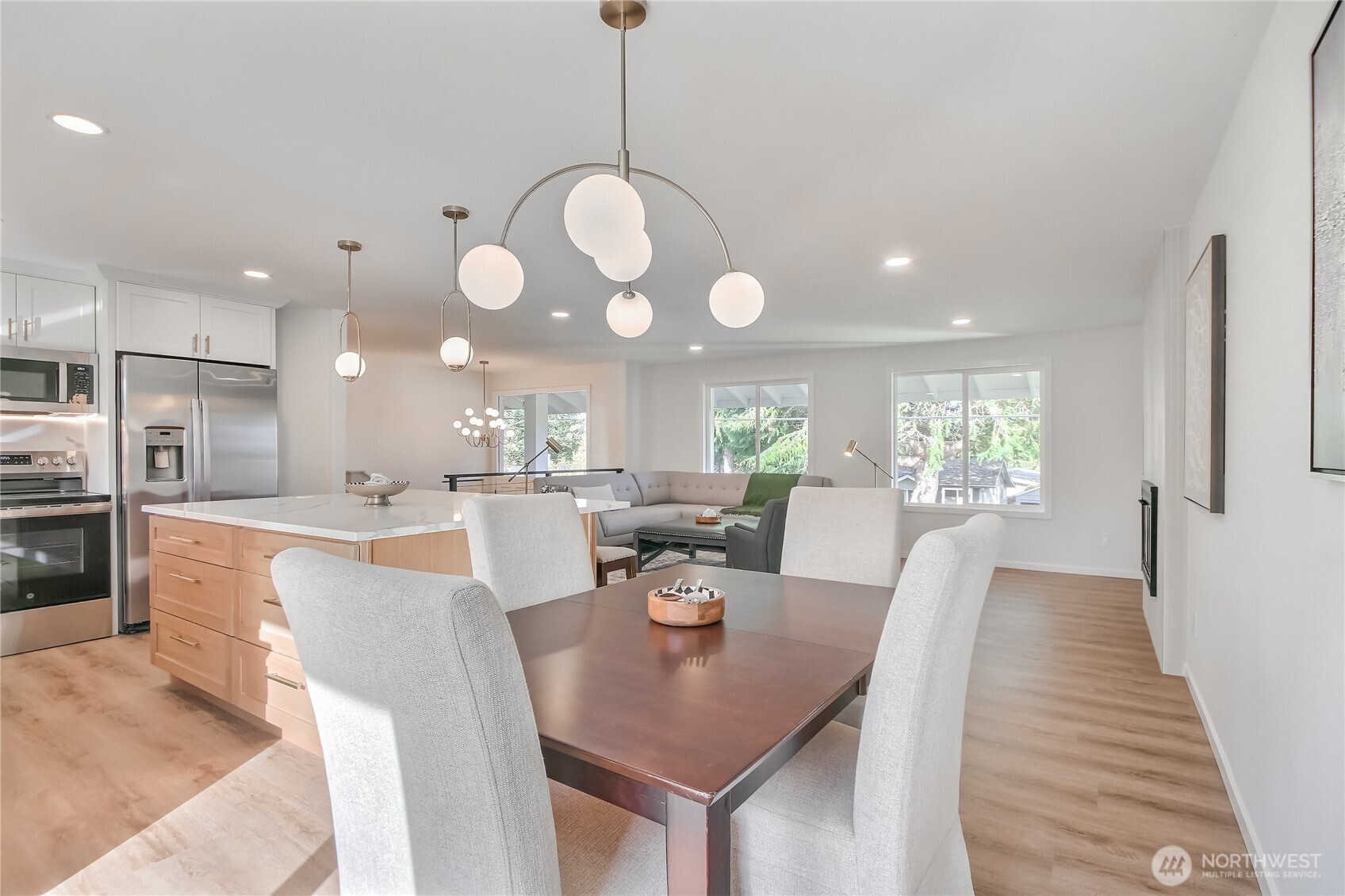 1229 Southwest 158th Street Burien, WA 98166 - Photo 11 of 40 a view of a dining room and livingroom with furniture wooden floor a chandelier