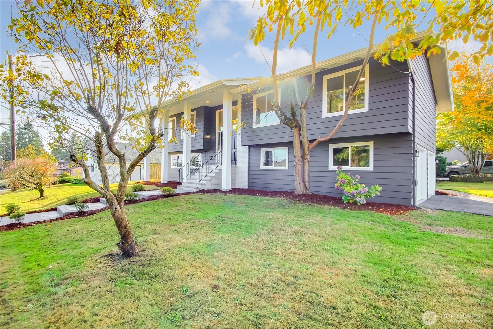 1229 Southwest 158th Street Burien, WA 98166 - Photo 3 of 40 a front view of a house with a garden