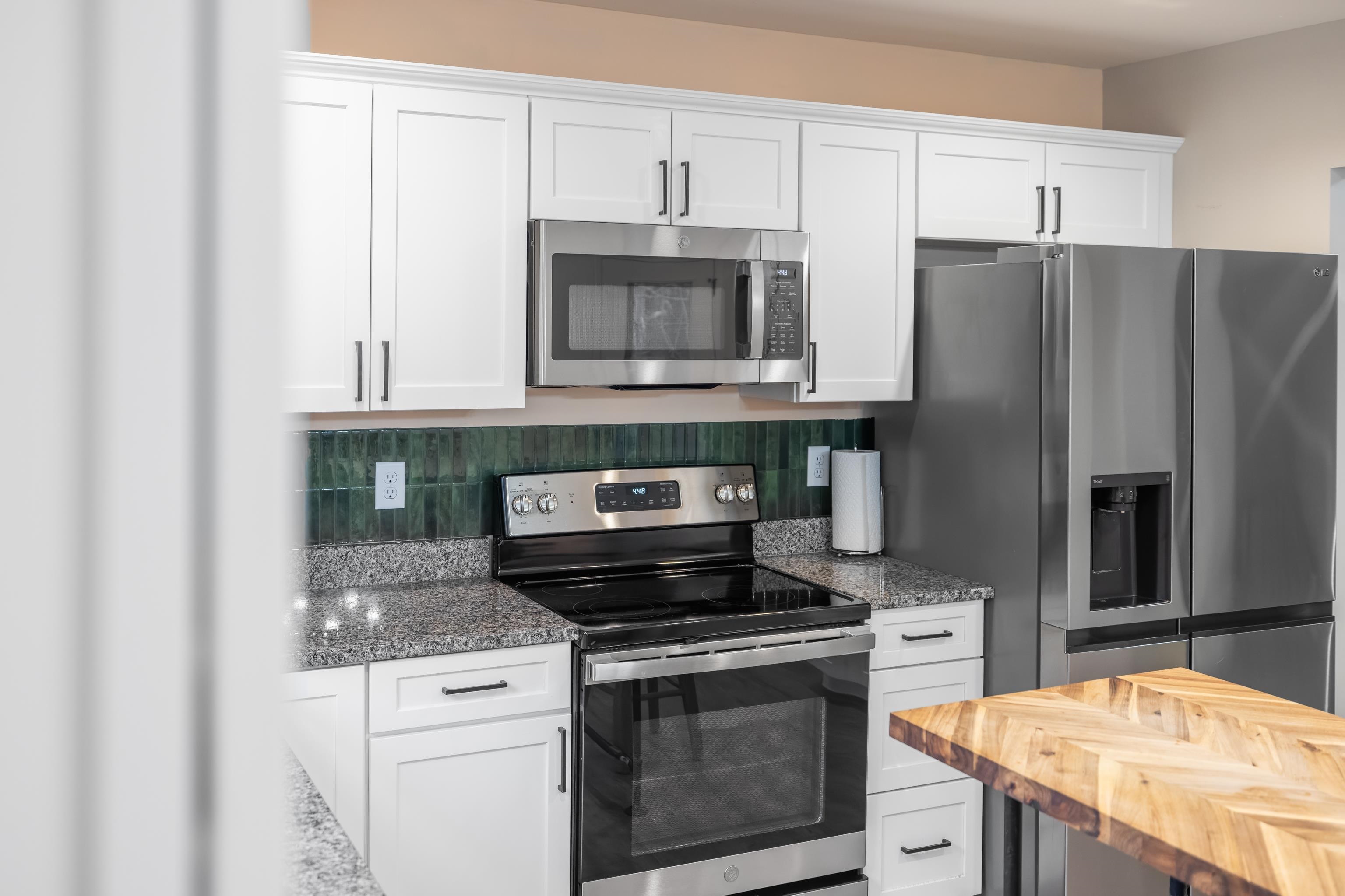 167 Raintree Road Verona, VA 24482 - Photo 16 of 75 a kitchen with granite countertop a stove and a microwave