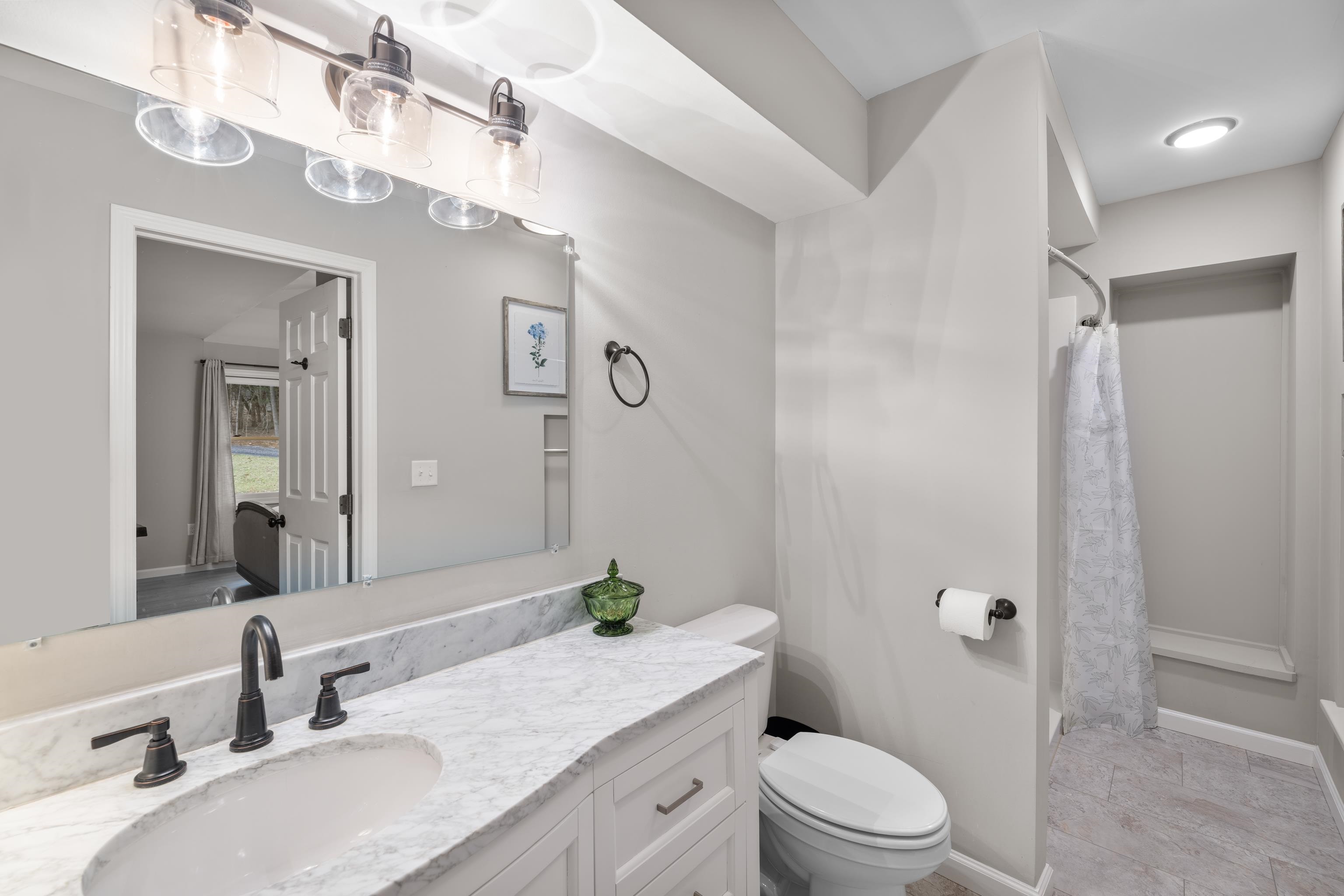 167 Raintree Road Verona, VA 24482 - Photo 28 of 75 a bathroom with a granite countertop sink toilet a large mirror a shower and a mirror
