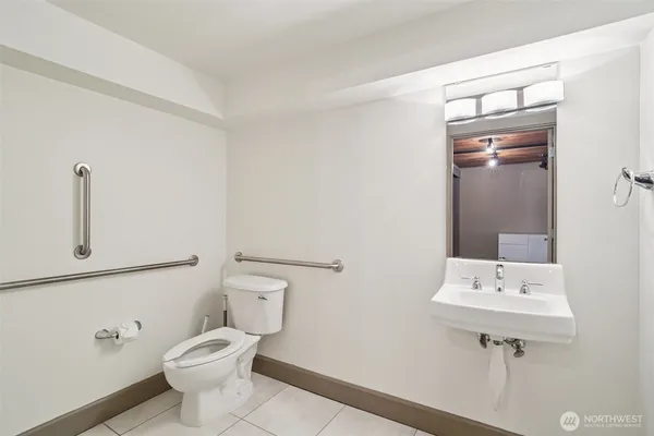 a bathroom with a sink a toilet and mirror