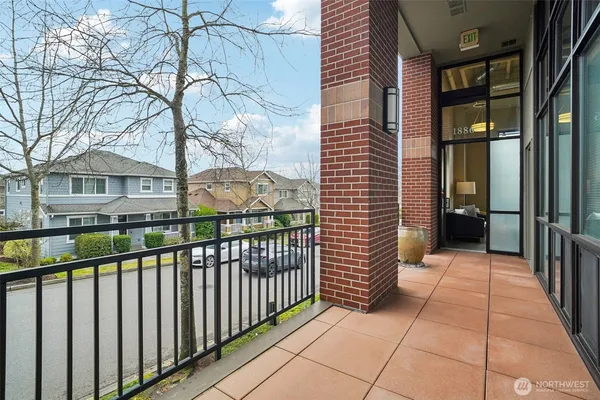 a view of a brick house with a small yard