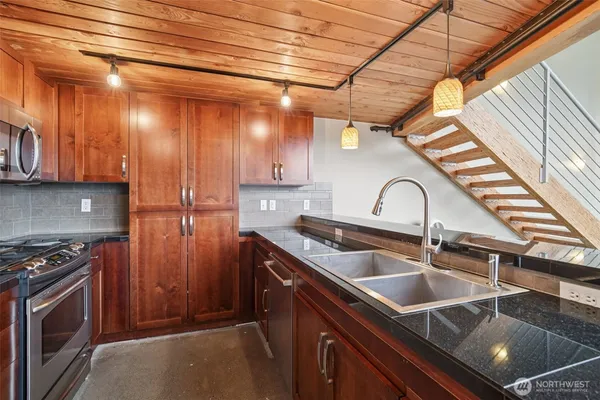 a kitchen that has a sink and a stove
