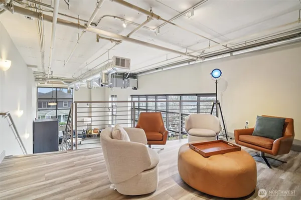a balcony with furniture and wooden floor
