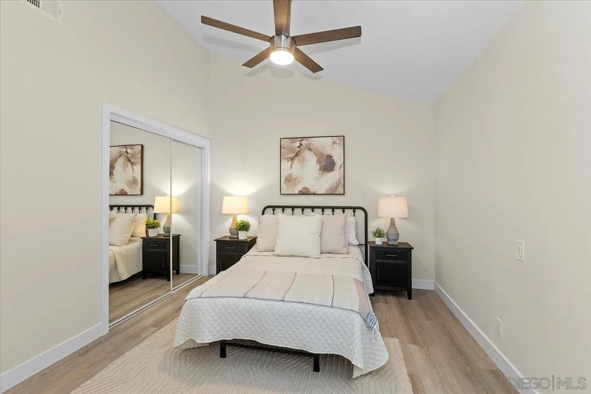 3615 Vista Bella, Unit 30 Oceanside, CA 92057 - Photo 20 of 38 a bed room with a bed and a chandelier