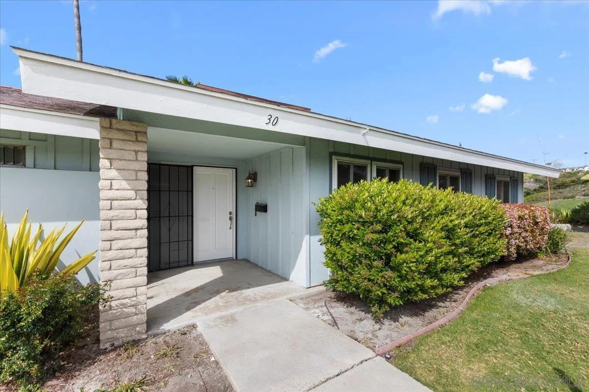 3615 Vista Bella, Unit 30 Oceanside, CA 92057 - Photo 2 of 38 a front view of a house with garden