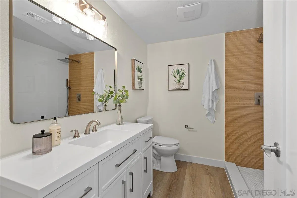 3615 Vista Bella, Unit 30 Oceanside, CA 92057 - Photo 22 of 38 a bathroom with a toilet sink and mirror