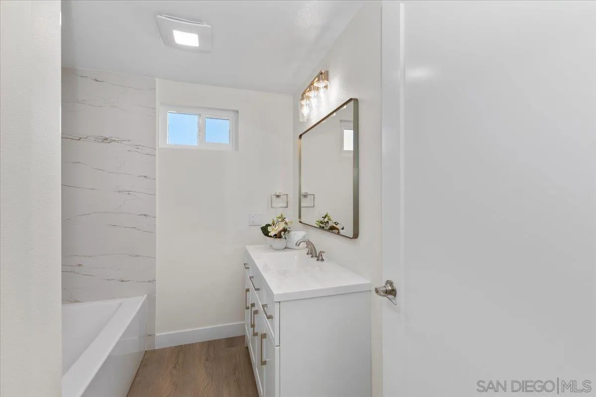 3615 Vista Bella, Unit 30 Oceanside, CA 92057 - Photo 24 of 38 a bathroom with a bathtub sink vanity and mirror