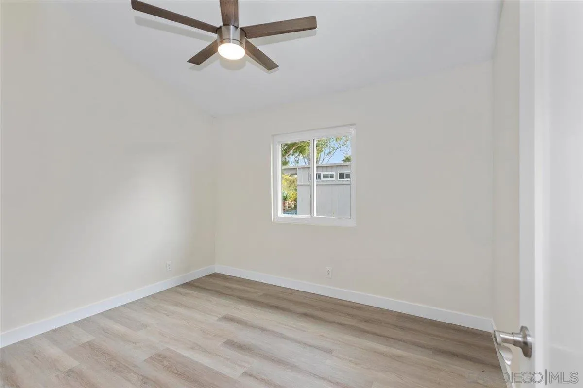 3615 Vista Bella, Unit 30 Oceanside, CA 92057 - Photo 25 of 38 an empty room with a window and ceiling fan