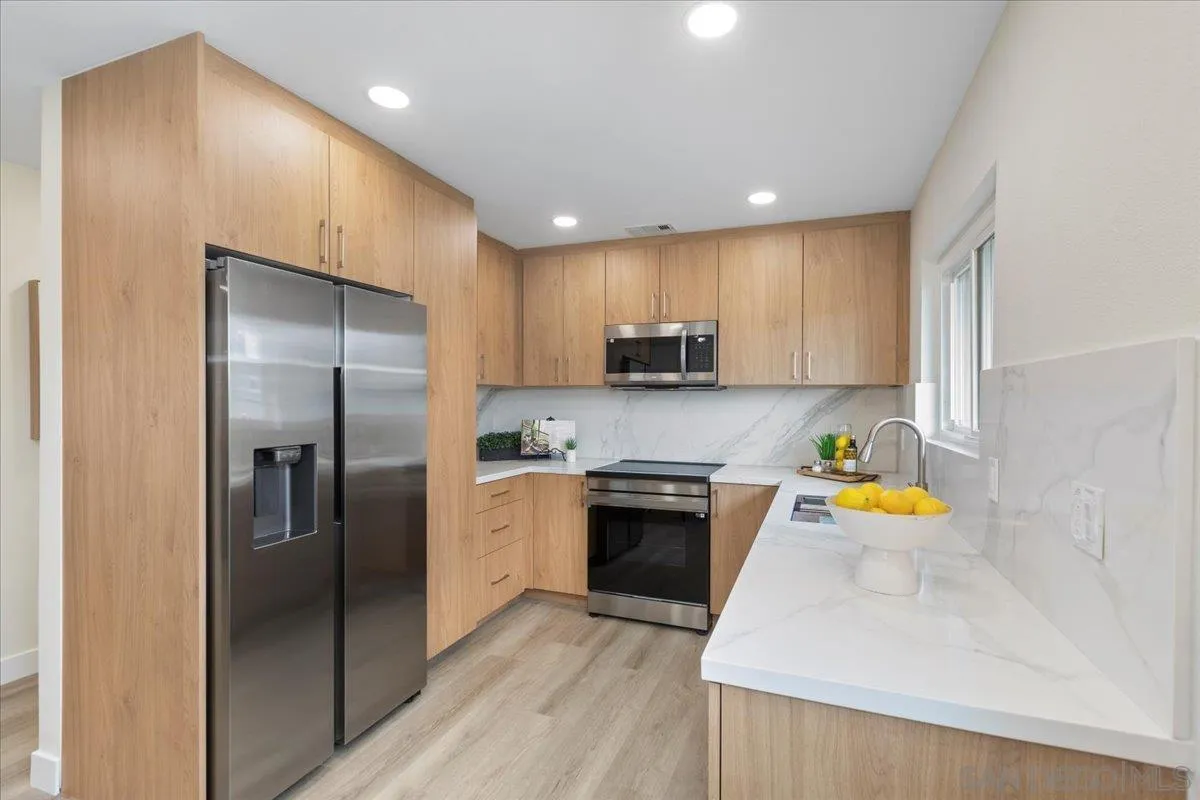 3615 Vista Bella, Unit 30 Oceanside, CA 92057 - Photo 8 of 38 a kitchen with stainless steel appliances granite countertop a refrigerator a stove top oven a sink and dishwasher