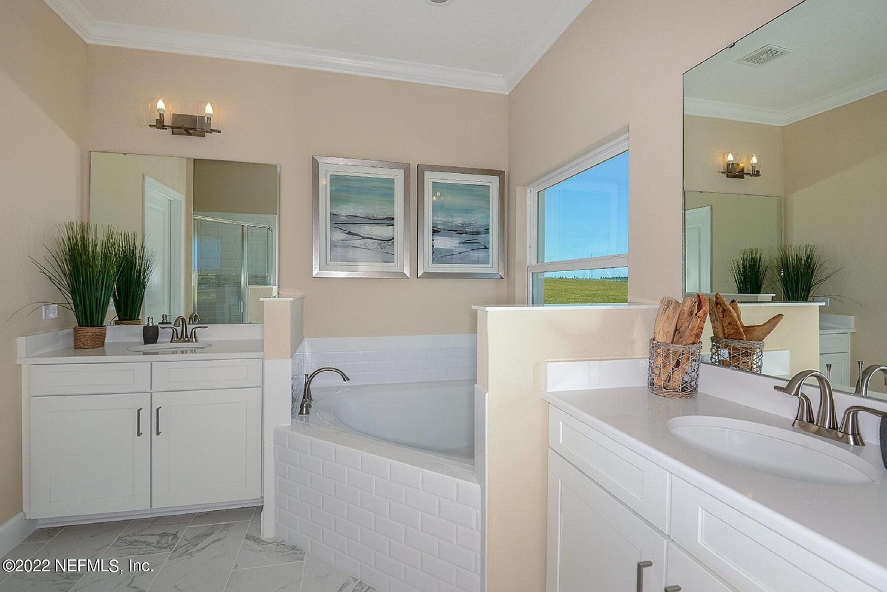 997 Silver Landing Drive, Unit 417 St. Augustine, FL 32092 - Photo 7 of 19 a bathroom with a sink and a bathtub