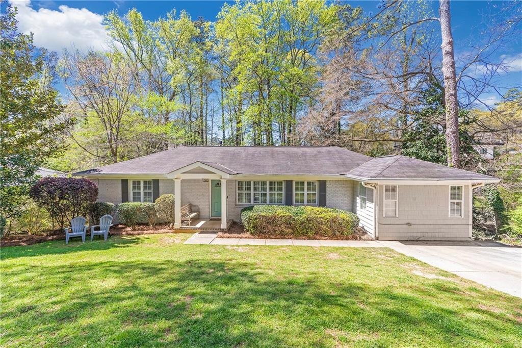 4616 Dalmer Road Northeast Atlanta, GA 30342 - Photo 1 of 1 a front view of a house with a garden