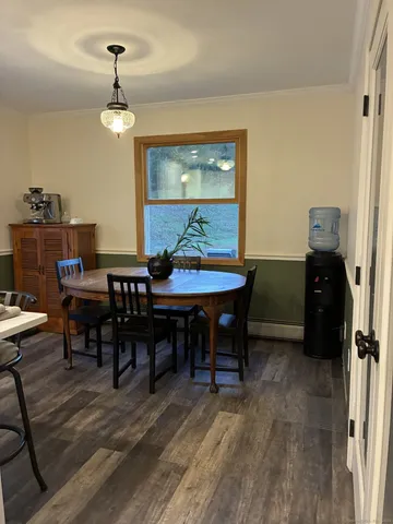 a view of a dining room with furniture and chandelier