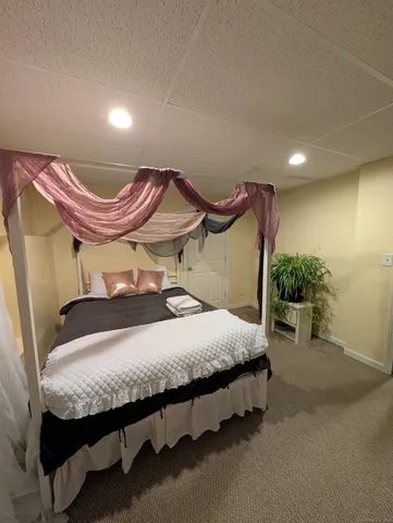 a bedroom with a bed and a mirror