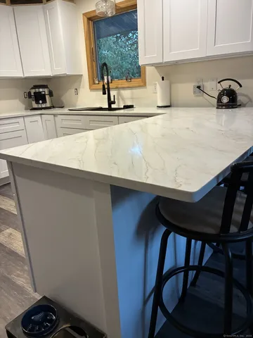 a kitchen with a sink a stove and cabinets