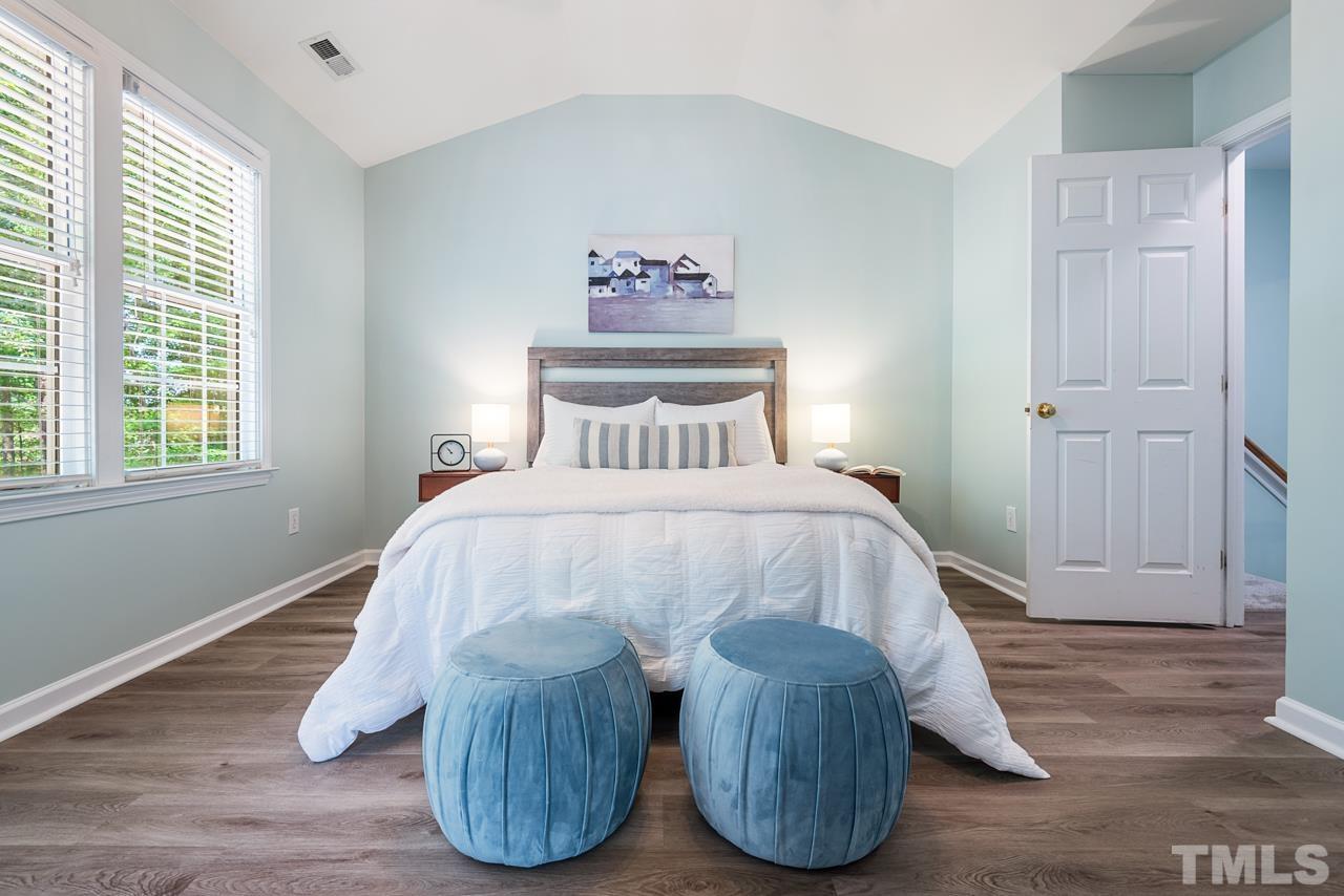 5626 Slide Rock Lane Raleigh, NC 27613 - Photo 27 of 46 a bedroom with bed and wooden floor