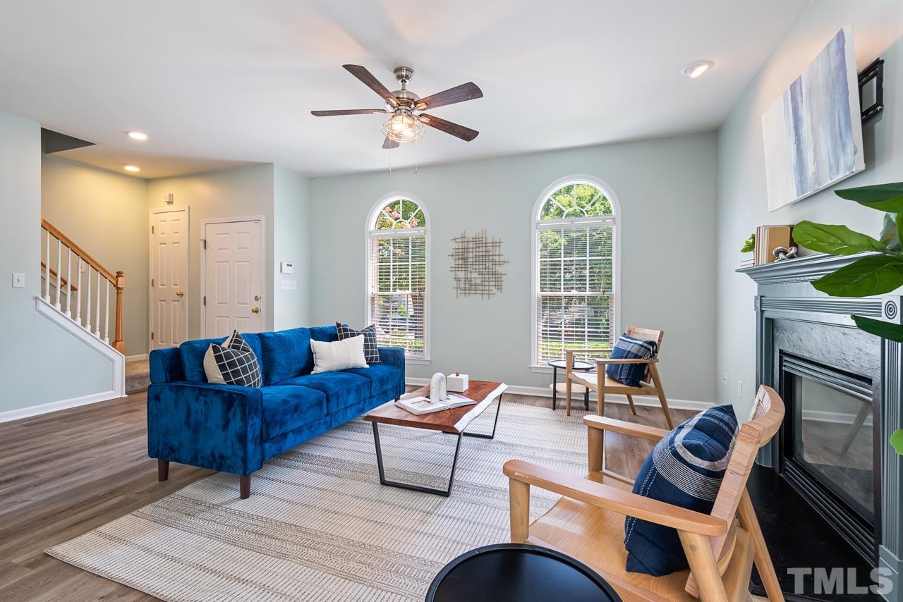 5626 Slide Rock Lane Raleigh, NC 27613 - Photo 5 of 46 a living room with furniture a fireplace and a large window