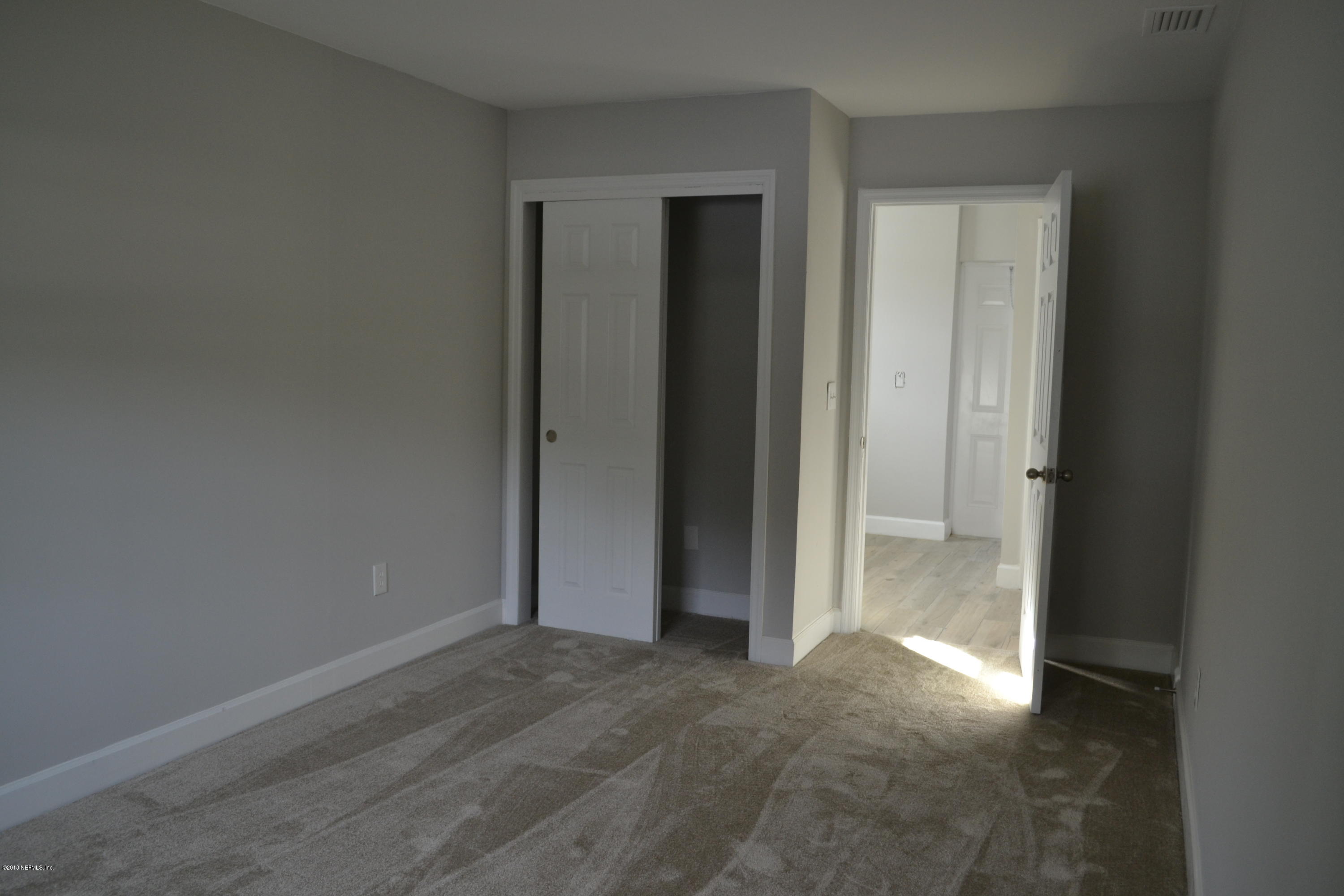 2726 Sam Road Jacksonville, FL 32216 - Photo 17 of 19 an empty room with closet and a bathroom