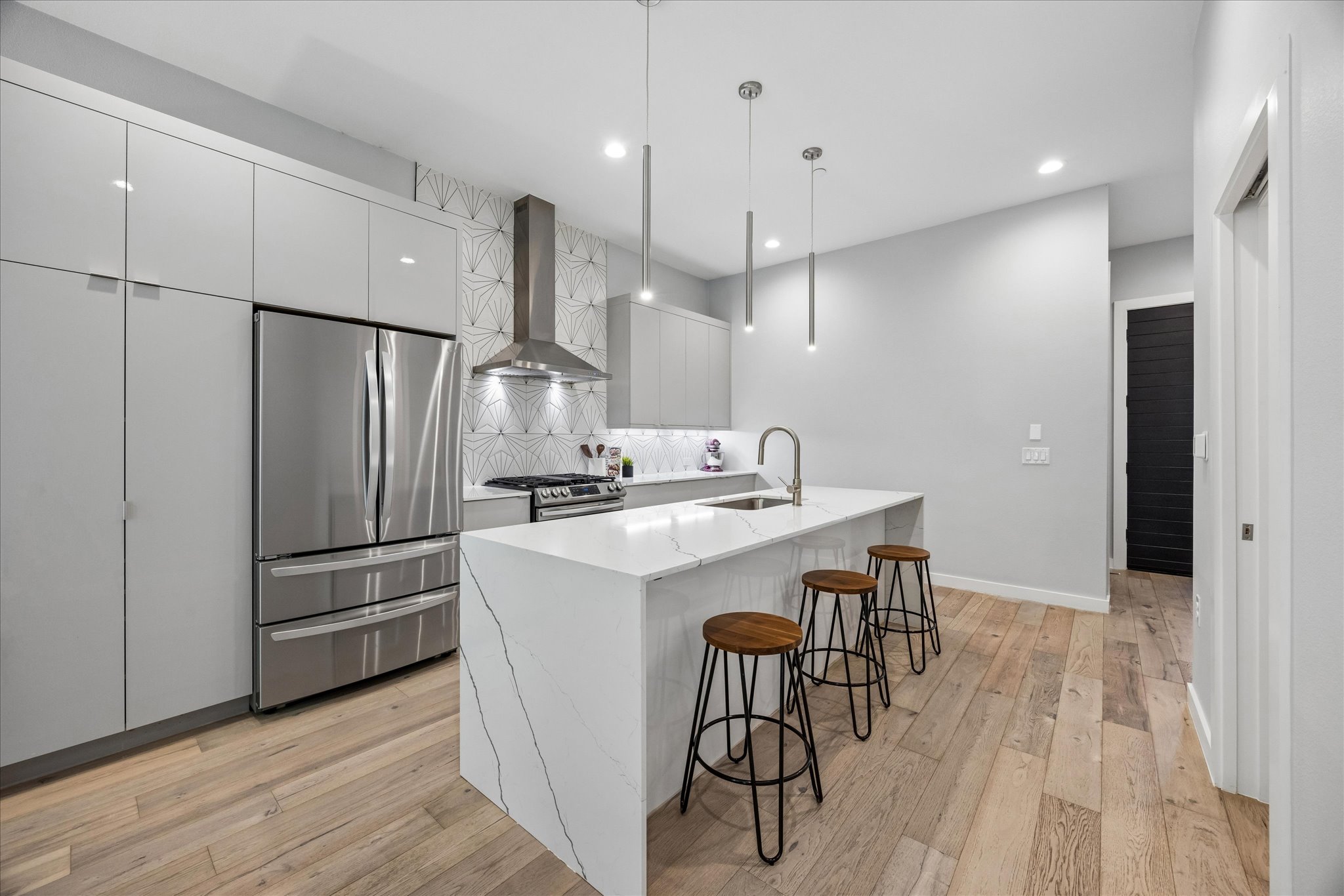 2108 Tillery Street, Unit 9 Austin, TX 78723 - Photo 5 of 25 Modern kitchen with marble countertops and waterfall island