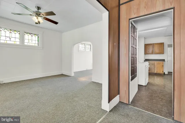 a view of a big room with closet and a chandelier fan