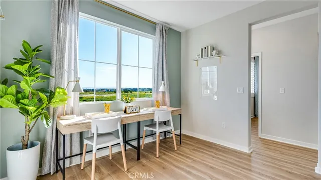 a view of a dining room with furniture window and wooden floor