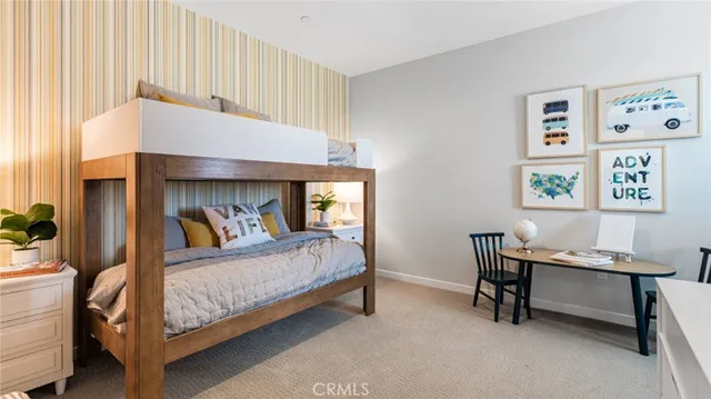 a bedroom with a bed a desk and chair