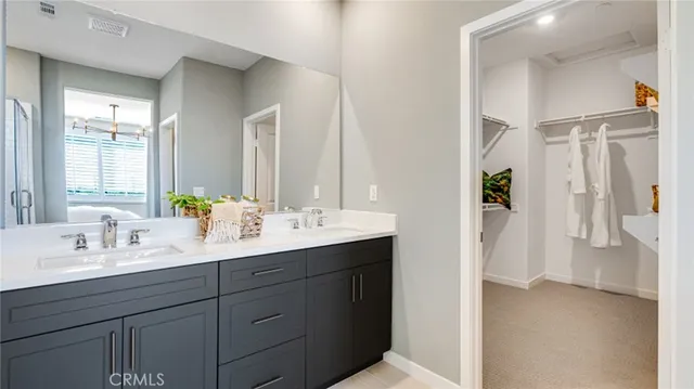 a bathroom with a double vanity sink mirror and double