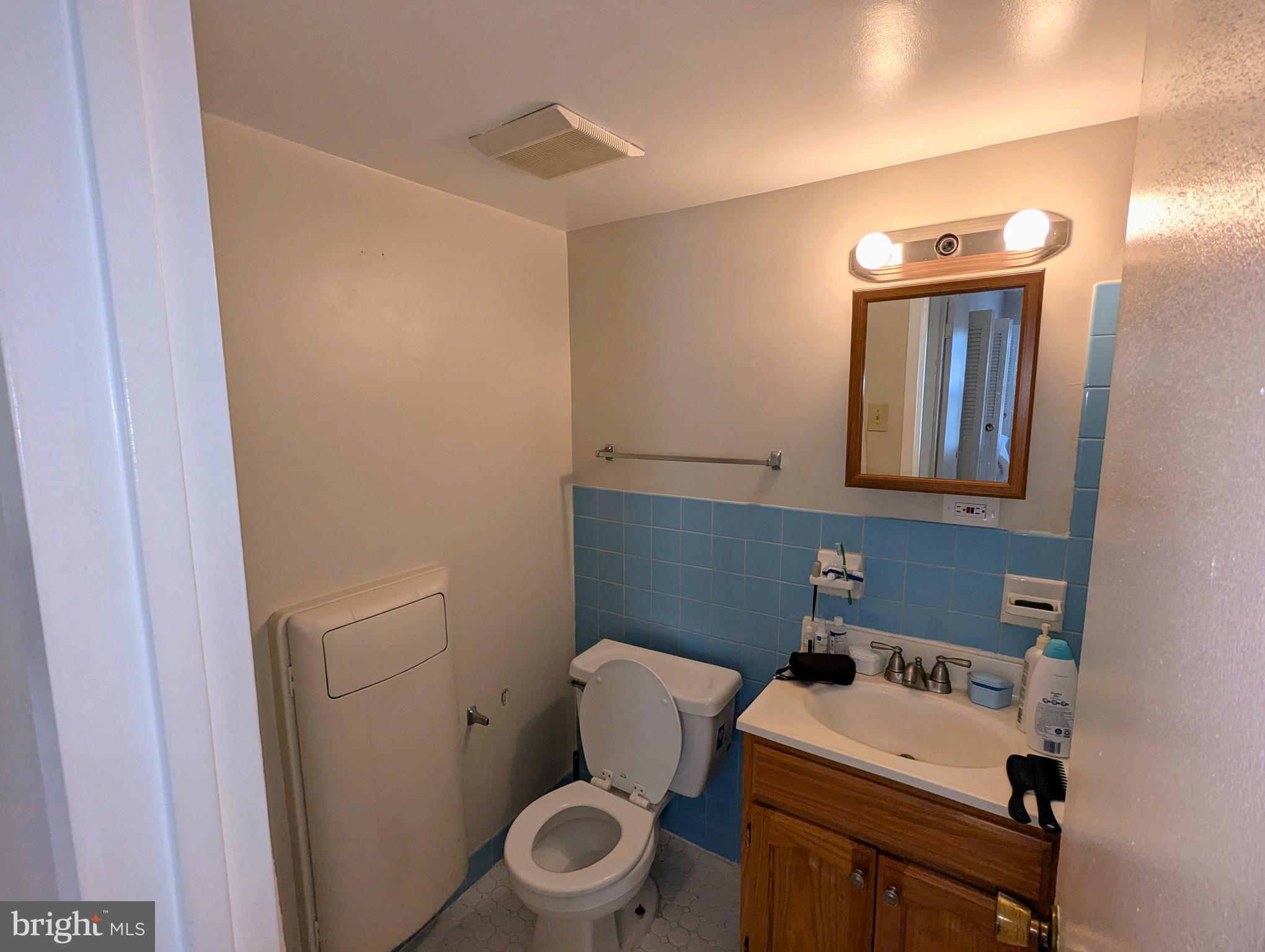 15 Canterbury Square, Unit 202 Alexandria, VA 22304 - Photo 11 of 14 a bathroom with a sink a toilet and mirror